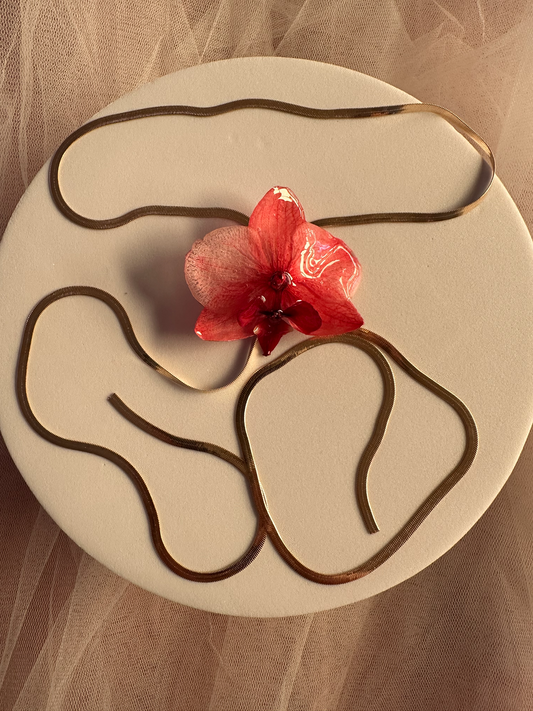 Red orchid on snake bone sliding chain